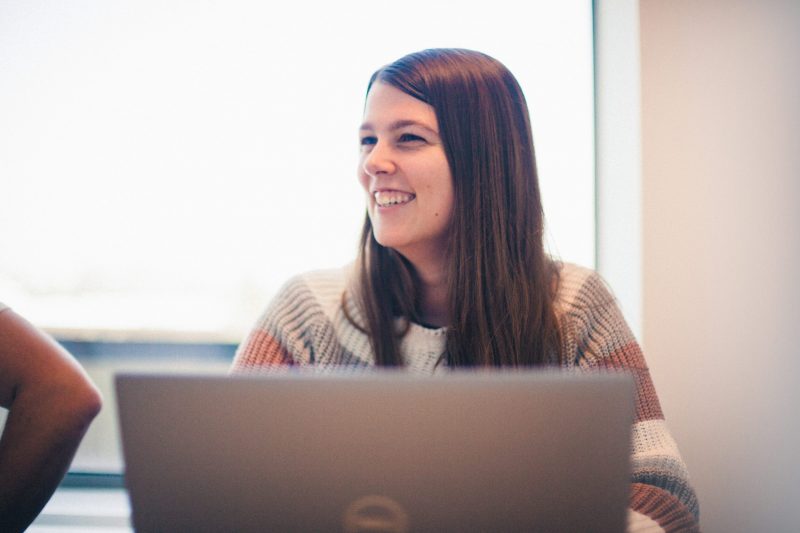 One our the ACEN SOC engineers smiling behind her computer screen.