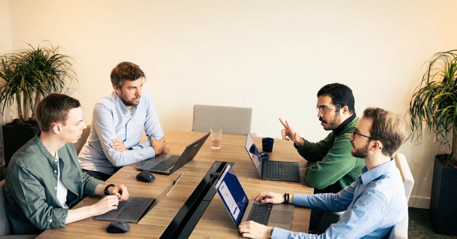 Photo of the PAM team in the office, during a meeting.